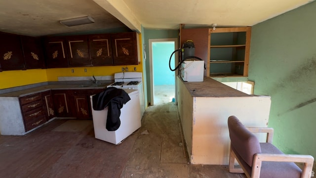 kitchen with dark brown cabinets, dark wood-type flooring, and sink
