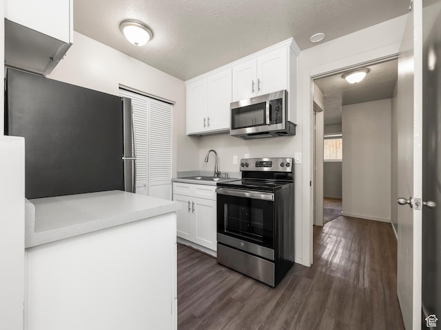 339 S 600 W, Provo, UT 84601 - kitchen with stainless steel appliances, a sink, dark wood-style flooring, and white cabinetry