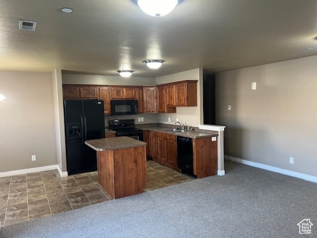 895 S Main St Unit E, Layton, UT 84041 - kitchen with sink, a center island, dark colored carpet, and black appliances