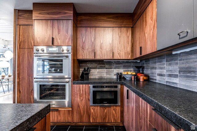 4345 S Zarahemla Dr, Salt Lake City, UT 84124 - kitchen with double oven, backsplash, and dark tile patterned floors