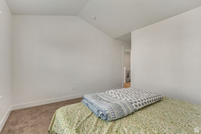 bedroom with carpet flooring and vaulted ceiling