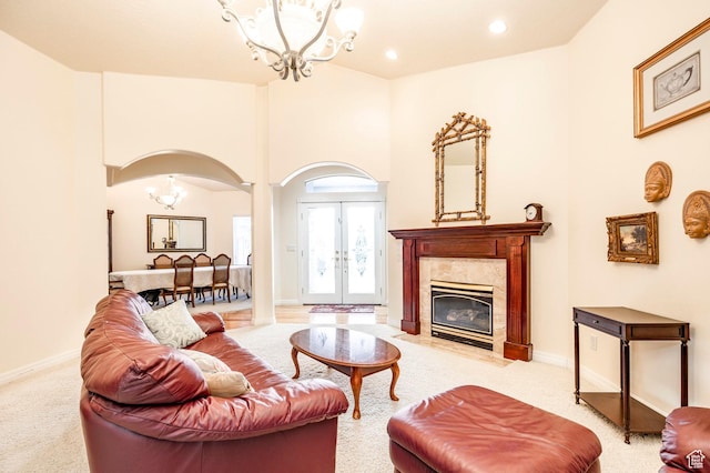 618 E Draper Heights Way S, Draper, UT 84020 - carpeted living room featuring a fireplace, french doors, a towering ceiling, and an inviting chandelier