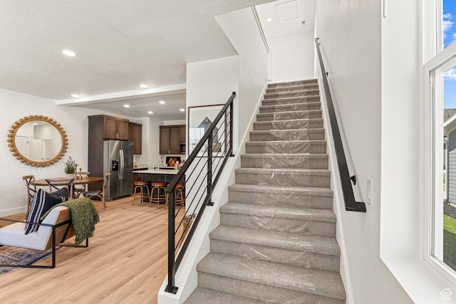 1044 E 1930 S Unit 419, Heber City, UT 84032 - staircase with wood finished floors, healthy amount of natural light, recessed lighting, and a textured ceiling