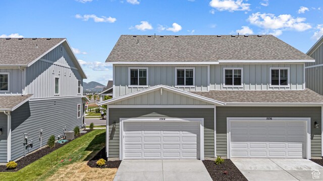 1044 E 1930 S Unit 419, Heber City, UT 84032 - view of front of property with board and batten siding, a shingled roof, driveway, and a garage