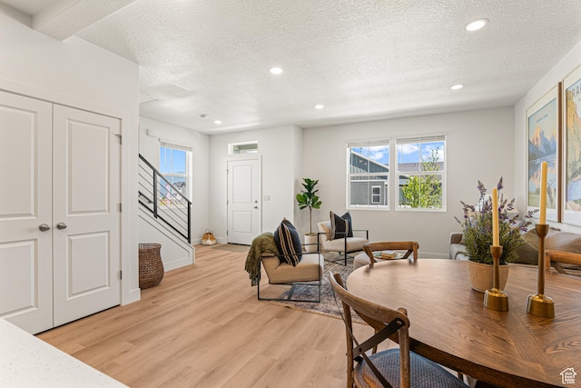 1044 E 1930 S Unit 419, Heber City, UT 84032 - dining space featuring a textured ceiling, stairs, light wood-style flooring, recessed lighting, and healthy amount of natural light