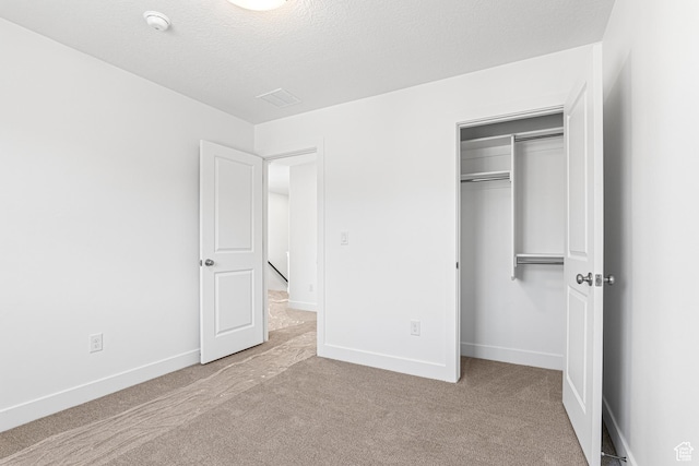 1044 E 1930 S Unit 419, Heber City, UT 84032 - unfurnished bedroom with carpet flooring, a closet, and a textured ceiling