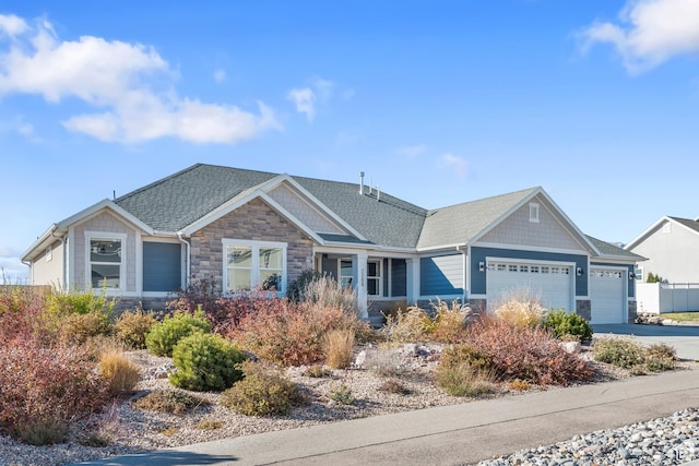 2388 E Horizon Dr Unit 907, Eagle Mountain, UT 84005 - view of front of home with stone siding, an attached garage, driveway, and roof with shingles