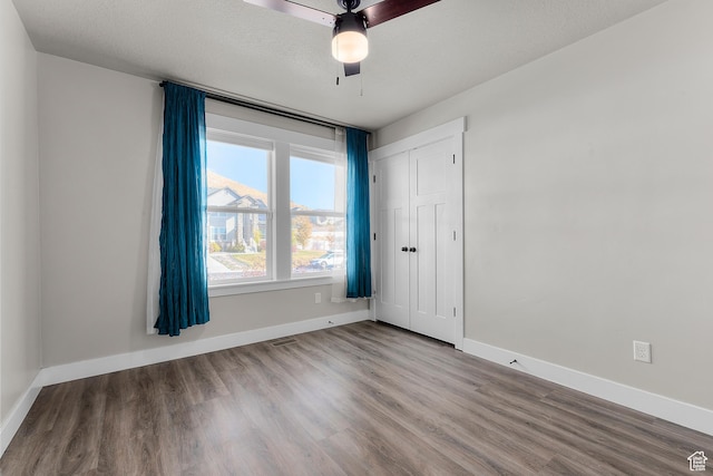 2388 E Horizon Dr Unit 907, Eagle Mountain, UT 84005 - unfurnished room with wood finished floors, baseboards, and ceiling fan