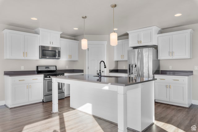 kitchen with white cabinets, light wood-type flooring, and stainless steel appliances