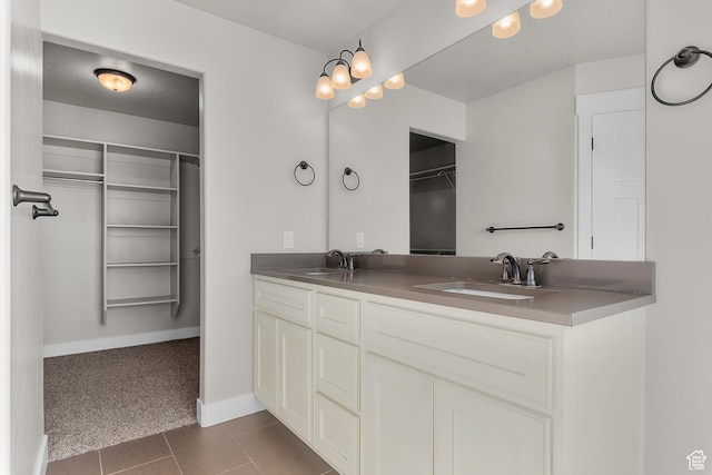 2388 E Horizon Dr Unit 907, Eagle Mountain, UT 84005 - full bath featuring double vanity, baseboards, a walk in closet, and tile patterned floors