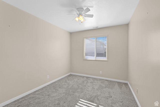 carpeted empty room with ceiling fan