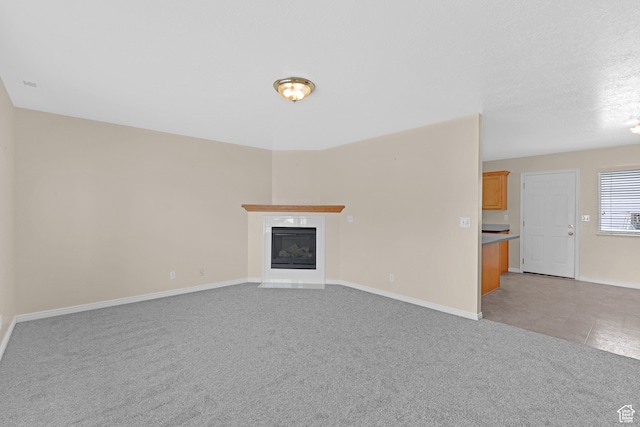 unfurnished living room with light colored carpet