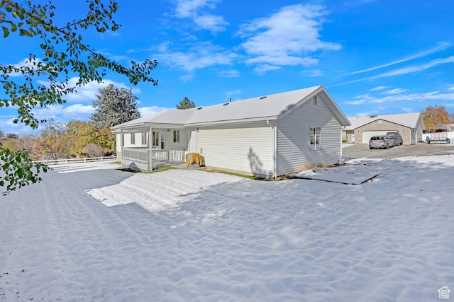 back of property featuring a porch and a garage