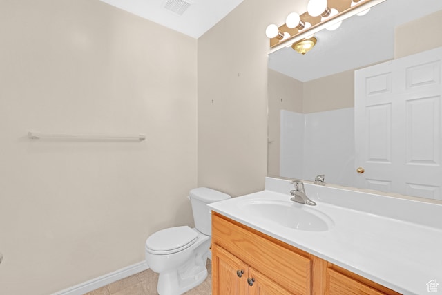 bathroom with tile patterned floors, vanity, and toilet