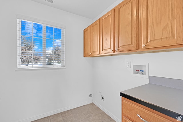 clothes washing area with electric dryer hookup, cabinets, and hookup for a washing machine