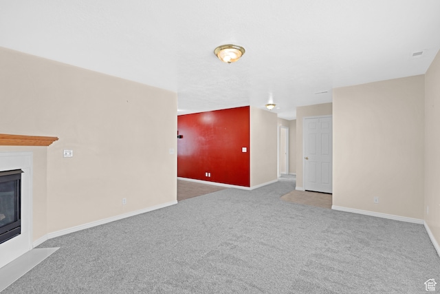 unfurnished living room featuring carpet floors