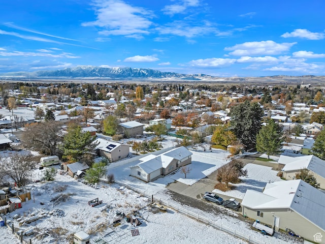 snowy aerial view featuring a mountain view