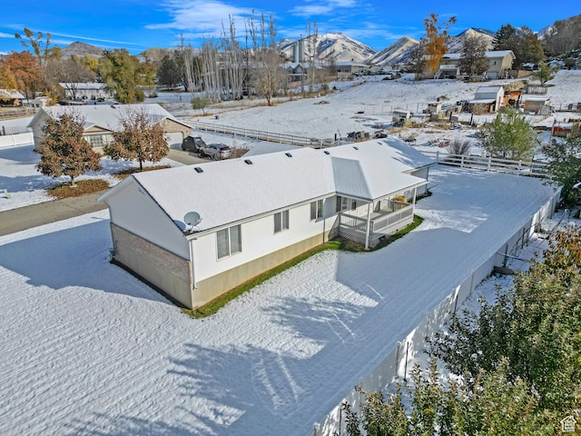 snowy aerial view with a mountain view