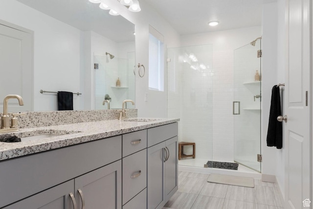 bathroom featuring vanity and a shower with door