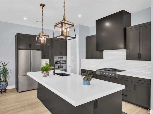 5349 W 3160 S, Hurricane, UT 84737 - kitchen featuring appliances with stainless steel finishes, light hardwood / wood-style flooring, a kitchen island with sink, and sink