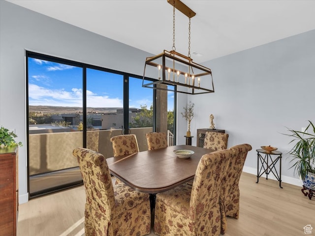 5349 W 3160 S, Hurricane, UT 84737 - dining space with light hardwood / wood-style flooring and an inviting chandelier