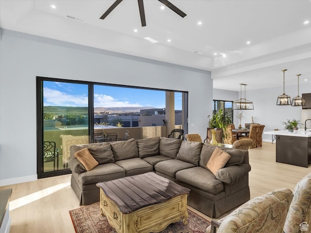 5349 W 3160 S, Hurricane, UT 84737 - living room with light hardwood / wood-style floors, a raised ceiling, and ceiling fan