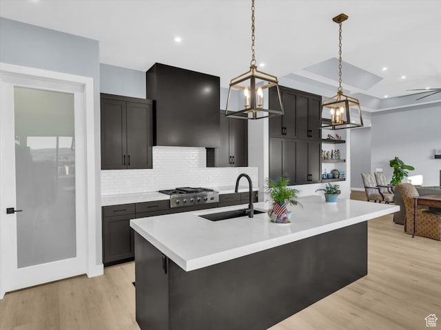5349 W 3160 S, Hurricane, UT 84737 - kitchen featuring a kitchen island with sink, sink, hanging light fixtures, light hardwood / wood-style flooring, and extractor fan