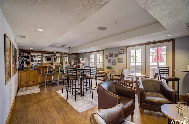 784 W Resort Dr Unit 206, Midway, UT 84049 - dining space featuring wood finished floors, recessed lighting, baseboards, a textured ceiling, and a community bar