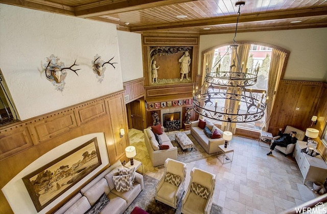 784 W Resort Dr Unit 206, Midway, UT 84049 - sitting room featuring wooden ceiling with exposed beams, a chandelier, a wainscoted wall, light stone finish flooring, and a decorative wall