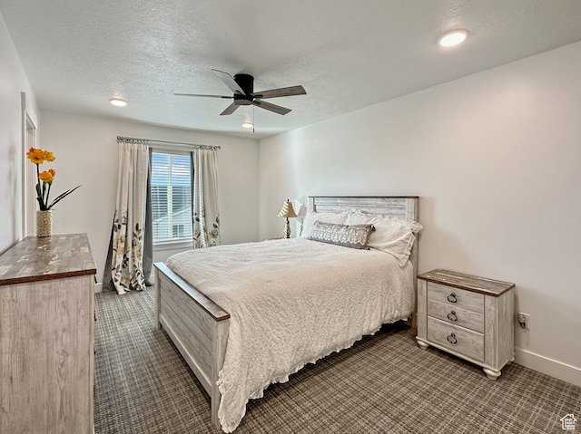 bedroom featuring ceiling fan, carpet floors, and a textured ceiling