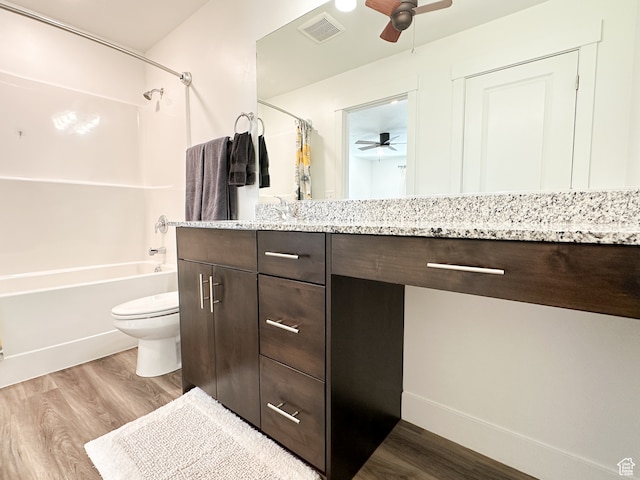 full bathroom with ceiling fan, hardwood / wood-style floors, vanity, and shower / tub combo
