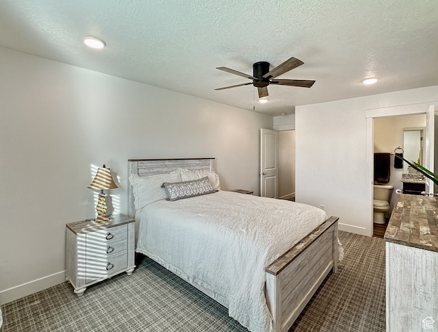 bedroom with a textured ceiling, ceiling fan, and ensuite bathroom