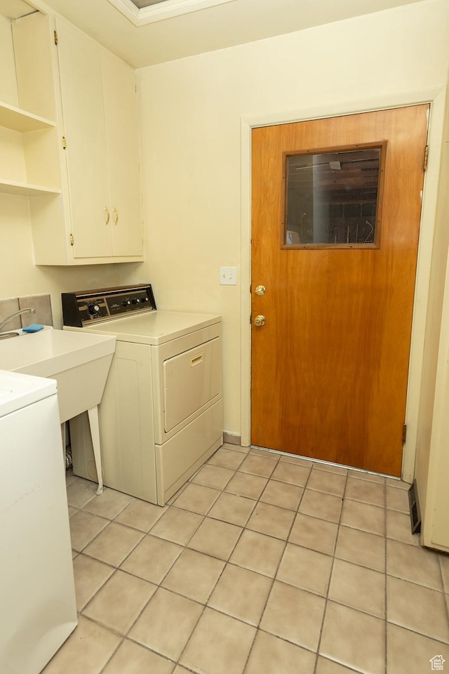 215 N 300 W, Salina, UT 84654 - laundry area featuring cabinet space, washing machine and clothes dryer, and light tile patterned floors