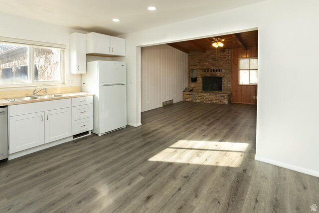 215 N 300 W, Salina, UT 84654 - kitchen featuring freestanding refrigerator, wood finished floors, a ceiling fan, white cabinetry, and beam ceiling