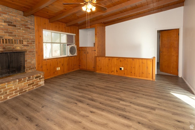 215 N 300 W, Salina, UT 84654 - unfurnished living room featuring a wood ceiling with exposed beams, ceiling fan, wood finished floors, wood walls, and a brick fireplace