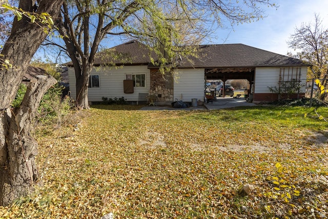 215 N 300 W, Salina, UT 84654 - rear view of house featuring a carport, a lawn, and roof with shingles