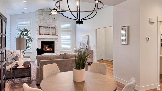 786 S 1260 W Unit 119, Heber City, UT 84032 - dining area featuring wood finished floors, a stone fireplace, high vaulted ceiling, and a chandelier