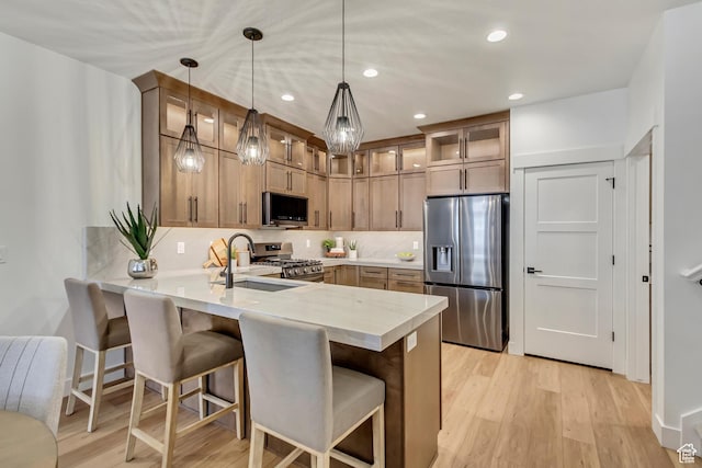 786 S 1260 W Unit 119, Heber City, UT 84032 - kitchen with stainless steel appliances, a peninsula, glass insert cabinets, light wood-style floors, and recessed lighting