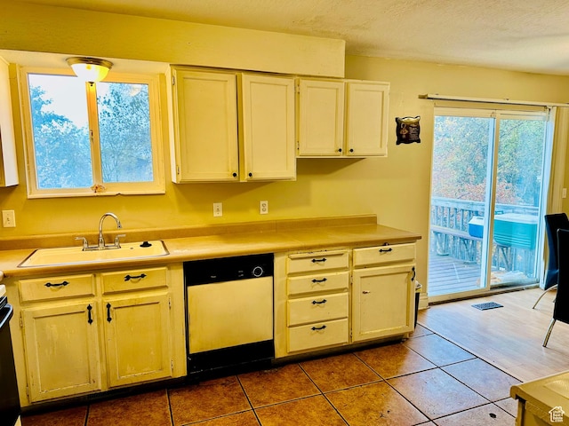 6301 S 2700 W, Taylorsville, UT 84129 - kitchen featuring dishwasher, a sink, light countertops, and tile patterned floors