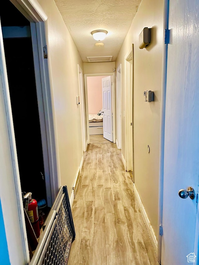 6301 S 2700 W, Taylorsville, UT 84129 - corridor with light wood finished floors, baseboards, and a textured ceiling