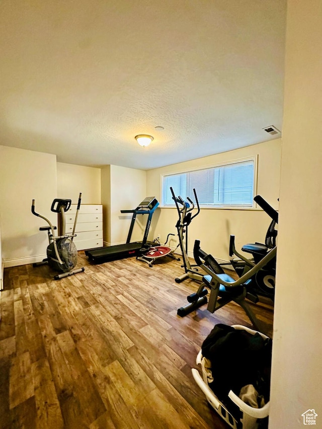 6301 S 2700 W, Taylorsville, UT 84129 - exercise room with wood finished floors, baseboards, and a textured ceiling