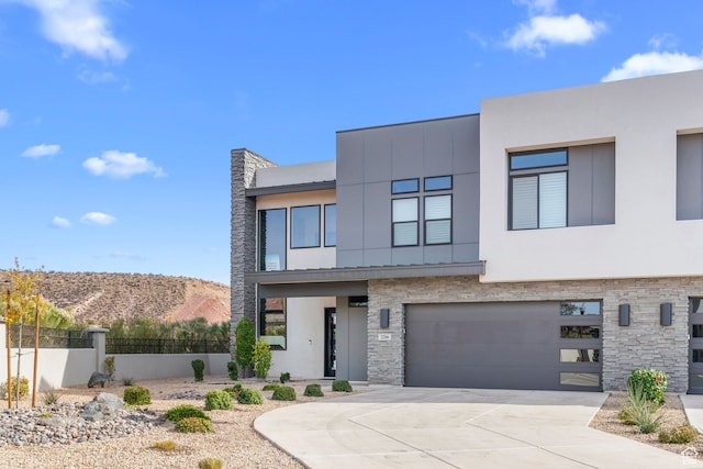 contemporary home featuring a mountain view and a garage