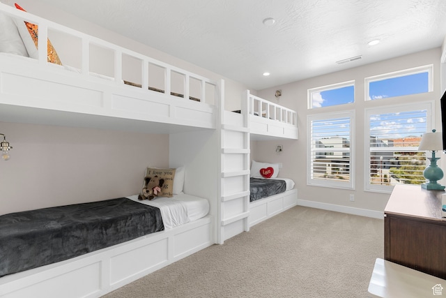 carpeted bedroom featuring a textured ceiling