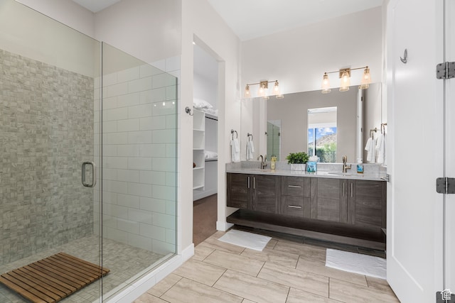 bathroom featuring vanity and a shower with door