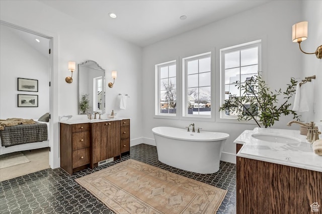bathroom with a washtub and vanity