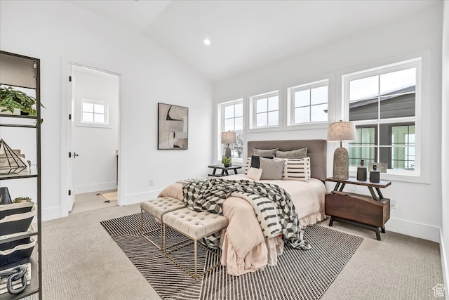 bedroom with lofted ceiling and light carpet