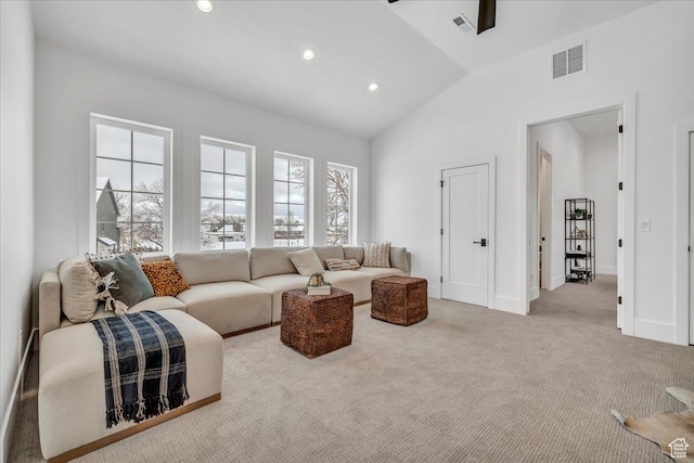 living room featuring light colored carpet and vaulted ceiling