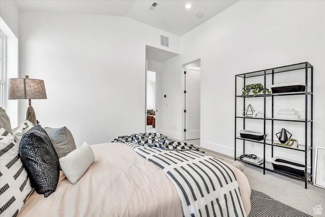 bedroom with carpet floors and lofted ceiling