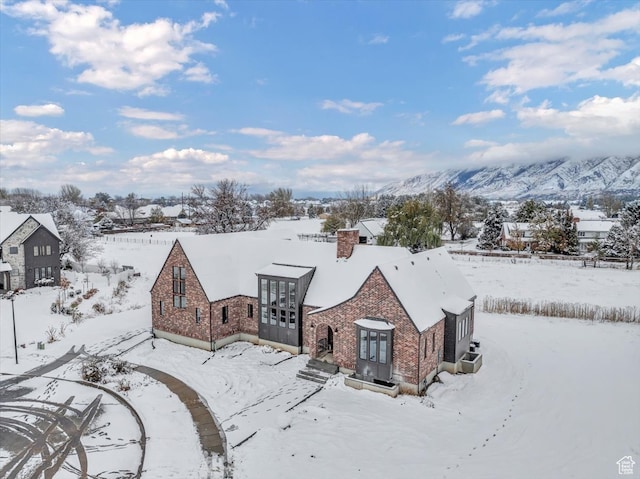 snowy aerial view with a mountain view