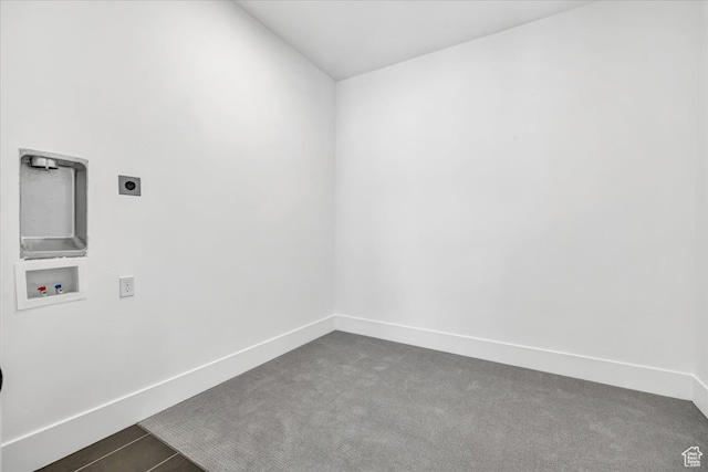 unfurnished room with dark carpet
